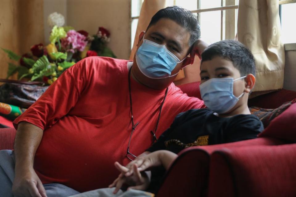 Rozaimi Rizal Mursal with his youngest nephew, Mohamad Faahil, who is nine. — Picture by Ahmad Zamzahuri