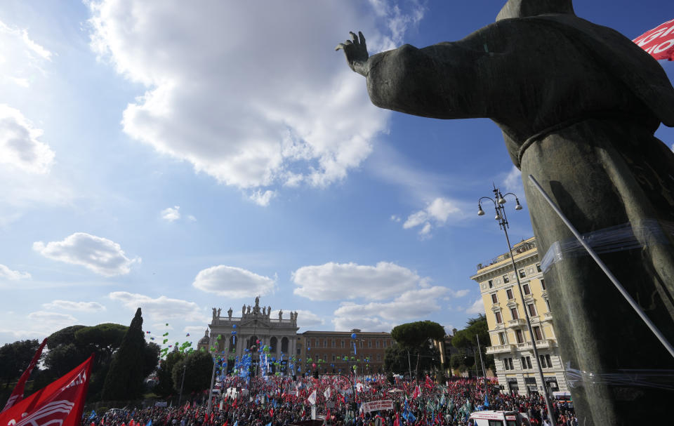 Demonstrators take part in a march organized by Italy's main labor unions, in Rome's St. John Lateran square, Saturday, Oct. 16, 2021. The march was called a week after protesters, armed with sticks and metal bars, smashed their way into the headquarters of CGIL, a left-leaning union, and trashed its office, during a demonstration to protest a government rule requiring COVID-19 vaccines or negative tests for workers to enter their offices. (AP Photo/Andrew Medichini)