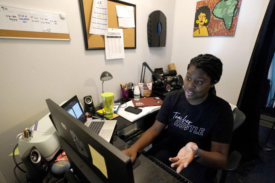 FILE - Chicago charter school teacher Angela McByrd works on her laptop to teach remotely from her home in Chicago, Sept. 24, 2020. After a six-week standoff with the teachers union, the district started bringing students back on a hybrid schedule just before spring 2021. It wasn’t until the following fall that students were back in school full time. (AP Photo/Nam Y. Huh)