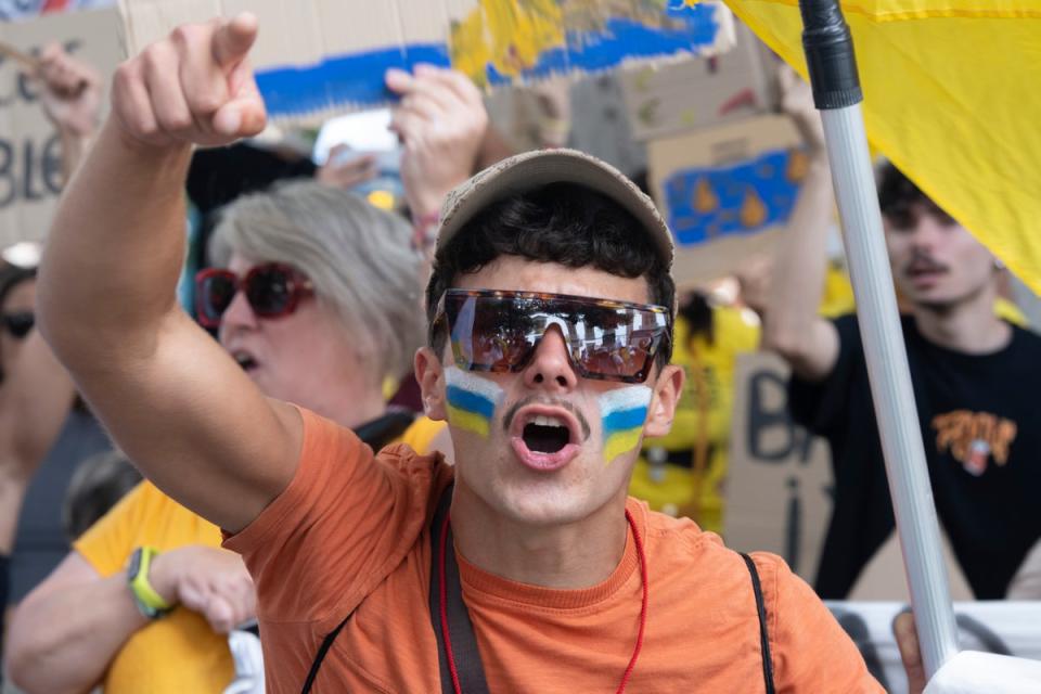 A man with the Canary Island flag painted on his face protests during a march against tourism in Santa Cruz de Tenerife, Spain, on Saturday (AP)