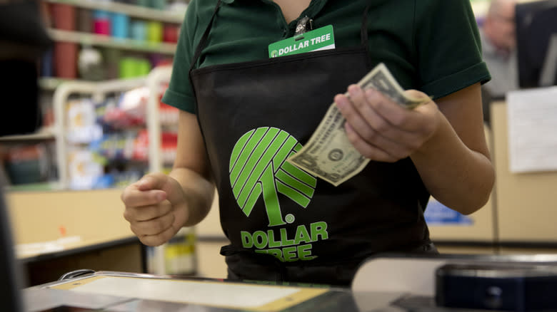 A Dollar Tree employee holding cash