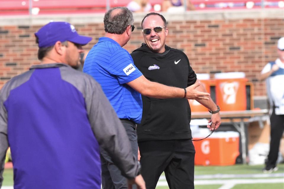 ACU head coach Adam Dorrel, right, laughs as he talks with SMU head coach Sonny Dykes before the Sept. 4 game at Gerald J. Ford Stadium in Dallas.