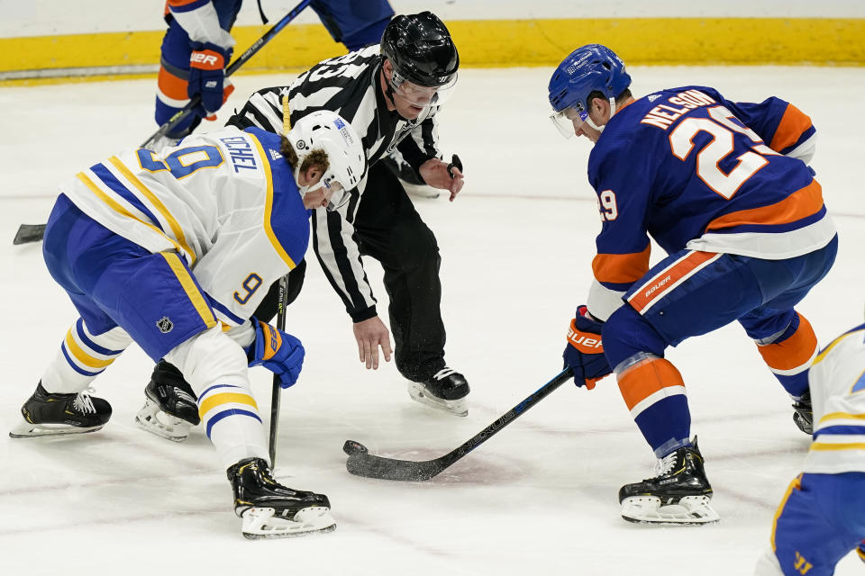 New York Islanders center Brock Nelson (29) wins a face-off against Buffalo Sabres center Jack Eichel (9) during the second period an NHL hockey game, Sunday, March 7, 2021, in Uniondale, N.Y. (AP Photo/John Minchillo)