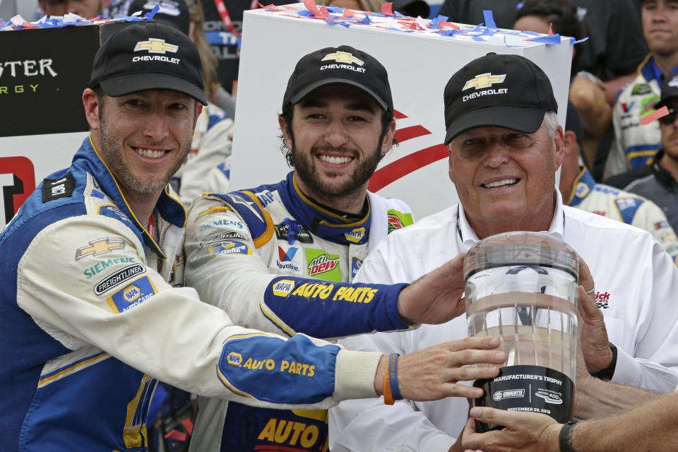 Chase Elliott, center, car owner Rick Hendrick, right, and crew chief Alan Gustafson celebrate in victory lane after Elliot won the NASCAR Cup Series auto race at Charlotte Motor Speedway in Concord, N.C., Sunday, Sept. 29, 2019. (AP Photo/Wesley Broome)