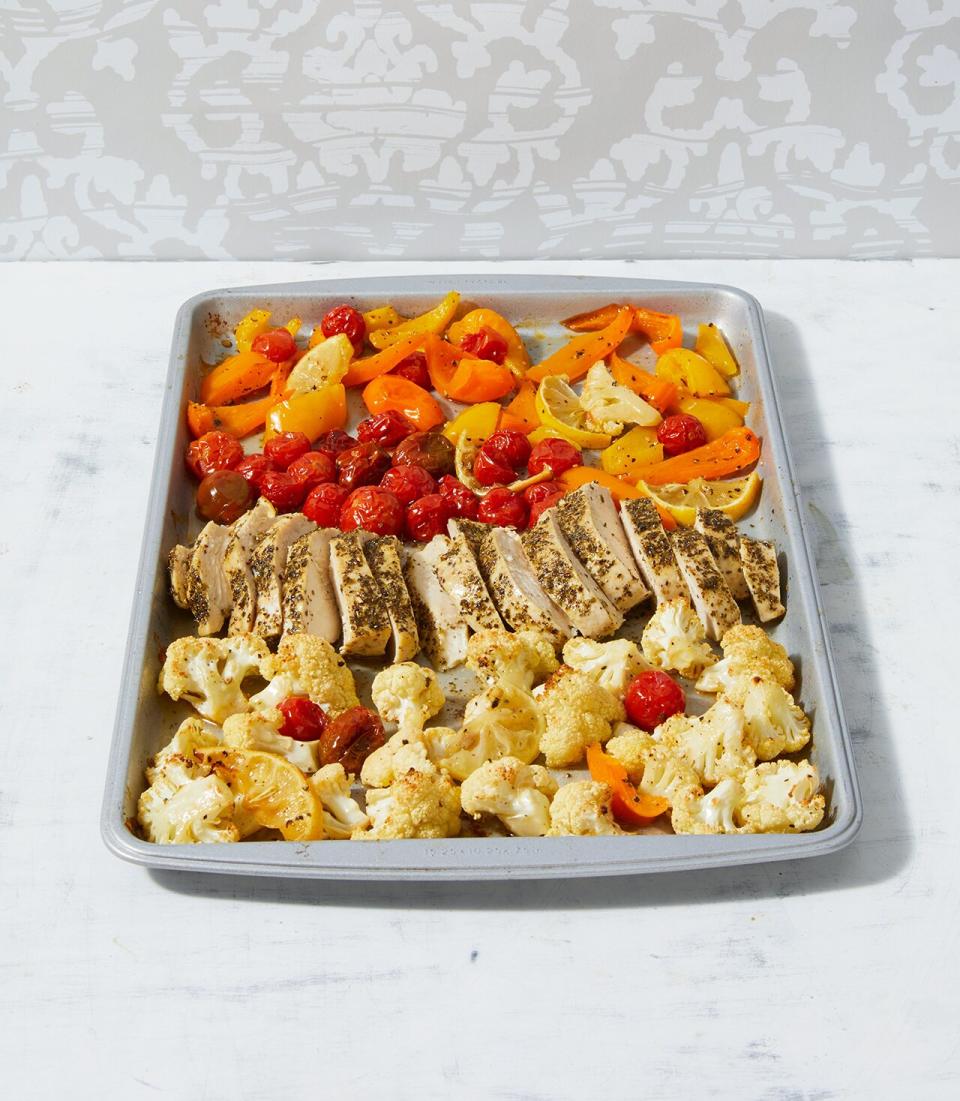 This Paleo chicken recipe cooks right alongside your dinner sides, too. Roast chicken, cauliflower, sweet peppers, and cherry tomatoes all on the same sheet pan for a super-delish dinner with minimal clean-up.