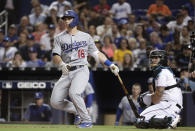 Los Angeles Dodgers' Will Smith watches his solo home run during the fourth inning of the team's baseball game against the Miami Marlins, Tuesday, Aug. 13, 2019, in Miami. At right is Marlins catcher Jorge Alfaro. (AP Photo/Lynne Sladky)