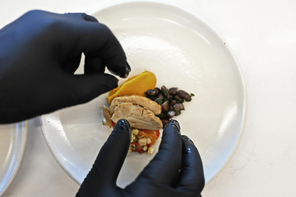 Slices of cultivated chicken rest on a plate at GOOD Meat's Alameda, Calif., headquarters on Thursday, Sept. 28, 2023. The company's cultivated chicken, which is grown from animal cells, is approved for sale in the United States and Singapore. (AP Photo/Noah Berger)