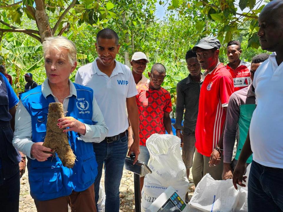 Cindy McCain, the new executive director of the U.N. World Food Program, holds up a yam while touring a farmers’ co-op in the Grand’Anse region of Haiti on Monday, June 19, 2023. The Réseaux des Organisations de Producteurs et Productrices de la Grand’Anse supplies locally produced crops to schools for WFP’s school feeding program.