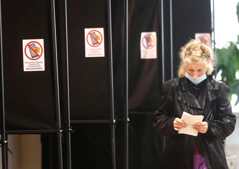 A woman walks to cast her vote during general election in Trakai