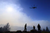 Firefighters monitor the Kincade Fire burning near Healdsburg, Calif., on Tuesday, Oct. 29, 2019. The overall weather picture in northern areas is improving, as powerful, dry winds bring extreme fire weather to Southern California. (AP Photo/Noah Berger)