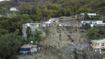 An aerial view of damaged houses after heavy rainfall triggered landslides that collapsed buildings and left as many as 12 people missing, in Casamicciola, on the southern Italian island of Ischia, Sunday, Nov. 27, 2022. Authorities said that the landslide that early Saturday destroyed buildings and swept parked cars into the sea left one person dead and 12 missing. (AP Photo/Salvatore Laporta)