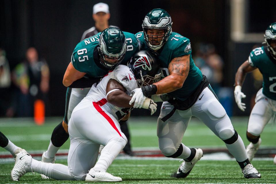 Philadelphia Eagles offensive tackle Lane Johnson (65) and offensive guard Brandon Brooks (79) work against Atlanta Falcons defensive tackle Grady Jarrett (97) during the first half of an NFL football game, Sunday, Sep. 12, 2021, in Atlanta. The Philadelphia Eagles won 32-6. (AP Photo/Danny Karnik)