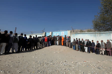 Afghan men line up to cast their votes during the parliamentary election at a polling station in Kabul, Afghanistan October 21, 2018. REUTERS/Omar Sobhani
