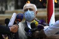 Iranian Foreign Minister Mohammad Javad Zarif speaks outside the Lebanese Foreign Ministry which damaged by last week's explosion that hit the seaport of Beirut, Lebanon, Friday, Aug. 14, 2020. (AP Photo/Hussein Malla)