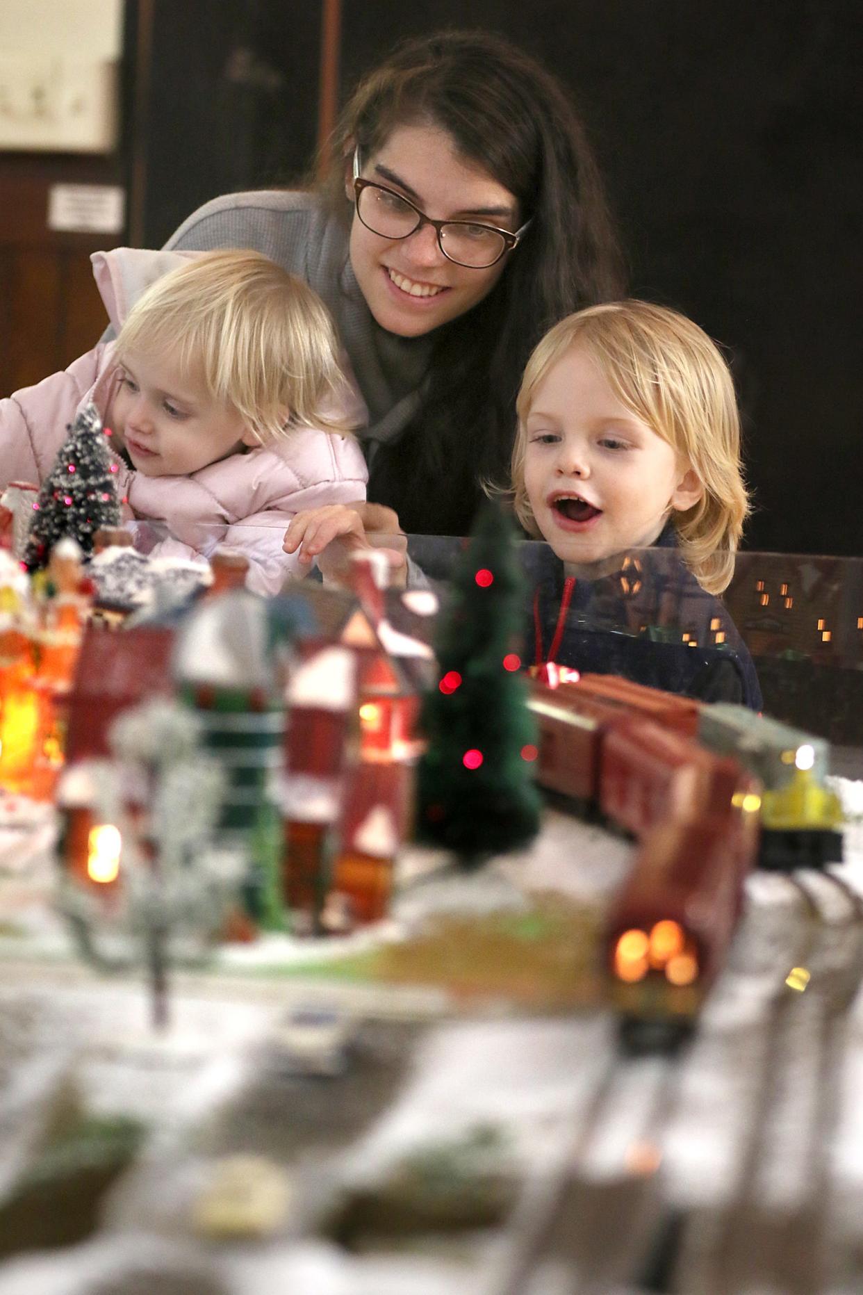 Angela Garvie with Amiria Cotton and Benjamin Garvie check out the Christmas trains display during the Spirit of Christmas Past event held Saturday, Dec. 3, 2022, at the Kings Mountain Historical Museum.