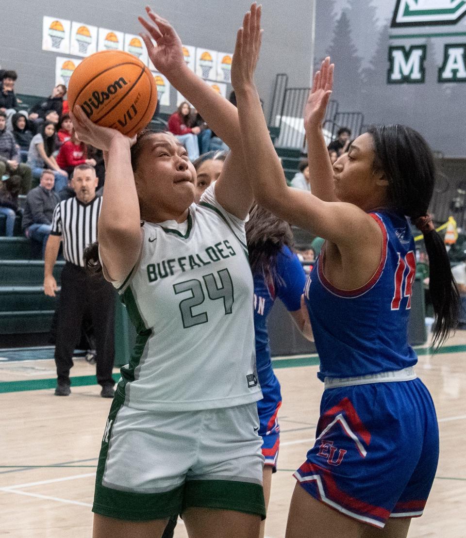 Manteca's Makayla Pelesasa, left, goes to the hoop against East Union's Donnese Payne during a girls varsity basketball game at Manteca High on Jan. 11, 2024. East Union won 55-44.