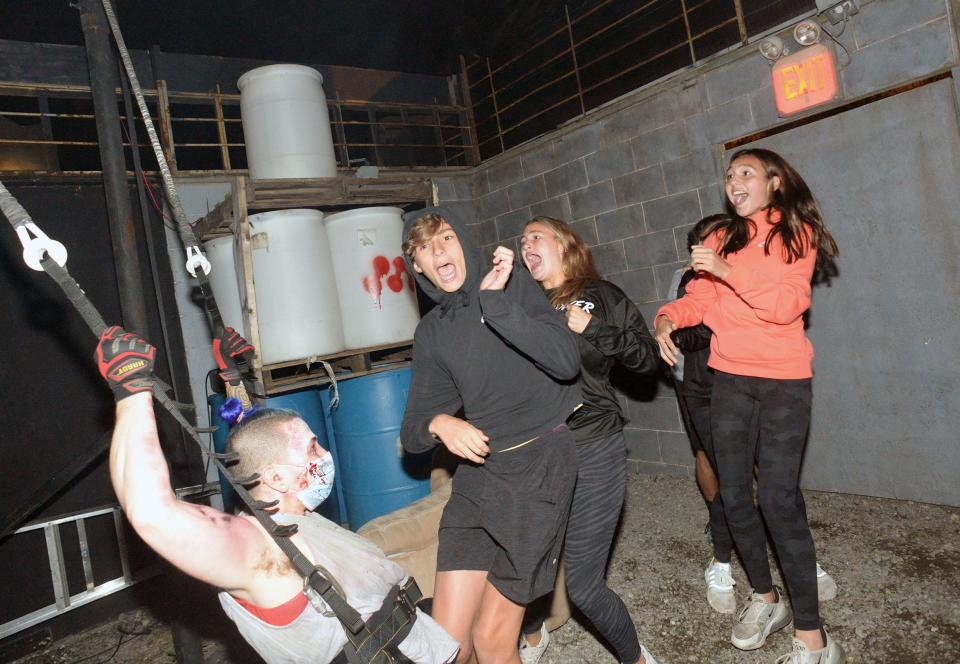 Oliver Loone, left, provides jaw-dropping terror at Barrett's Haunted Mansion in Abington on Saturday, Oct. 2, 2021.