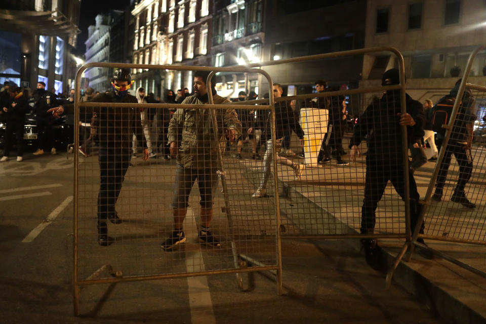 Protestors set up a barricade near of the Spanish parliament in Madrid, Spain, Wednesday, Oct. 16, 2019. Spain's government said Wednesday it would do whatever it takes to stamp out violence in Catalonia, where clashes between regional independence supporters and police have injured more than 200 people in two days. (AP Photo/Manu Fernandez)