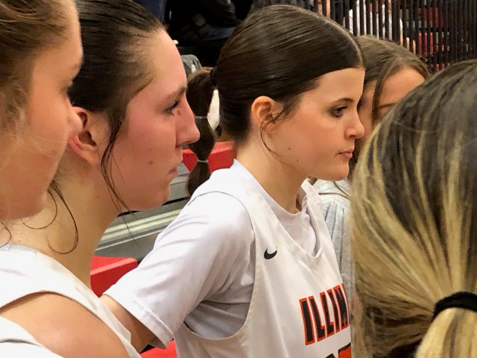 Illini Bluffs senior forward Lily Luczkowiak (second left) listens during a timeout on her way to a game-high 21 points to help IB upset No. 1 Galena, 47-41, in the IHSA Class 1A girls Super-Sectional at Brimfield on Monday, Feb. 26, 2024.