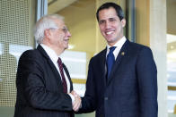 European Union foreign policy chief Josep Borrell, right, shakes hands with the leader of Venezuela's political opposition Juan Guaido prior to a meeting at EU headquarters on Wednesday, Jan. 22, 2020. (Aris Oikonomou, Pool Photo via AP)