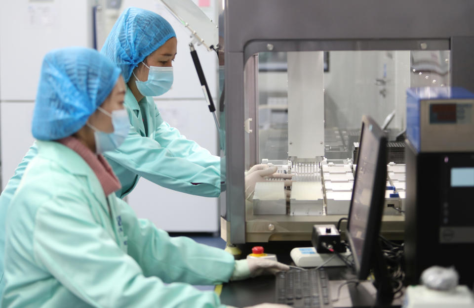 Technicians work at a genetic testing laboratory of BGI, formerly known as Beijing Genomics Institute, in Kunming, Yunnan province, China December 26, 2018. Picture taken December 26, 2018. REUTERS/Stringer  ATTENTION EDITORS - THIS IMAGE WAS PROVIDED BY A THIRD PARTY. CHINA OUT.