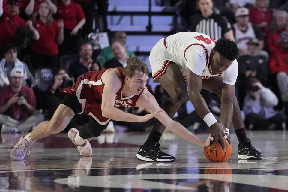 Alabama forward Grant Nelson (2) tries to steal from Georgia center Russel Tchewa (54) in the first half of an NCAA college basketball game Wednesday, Jan. 31, 2024, in Athens, Ga. (AP Photo/John Bazemore)