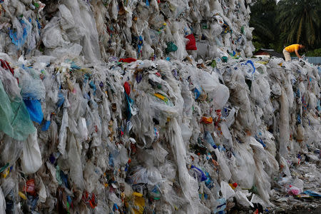 Plastic waste are piled outside an illegal recycling factory in Jenjarom, Kuala Langat, Malaysia October 14, 2018. REUTERS/Lai Seng Sin/Files