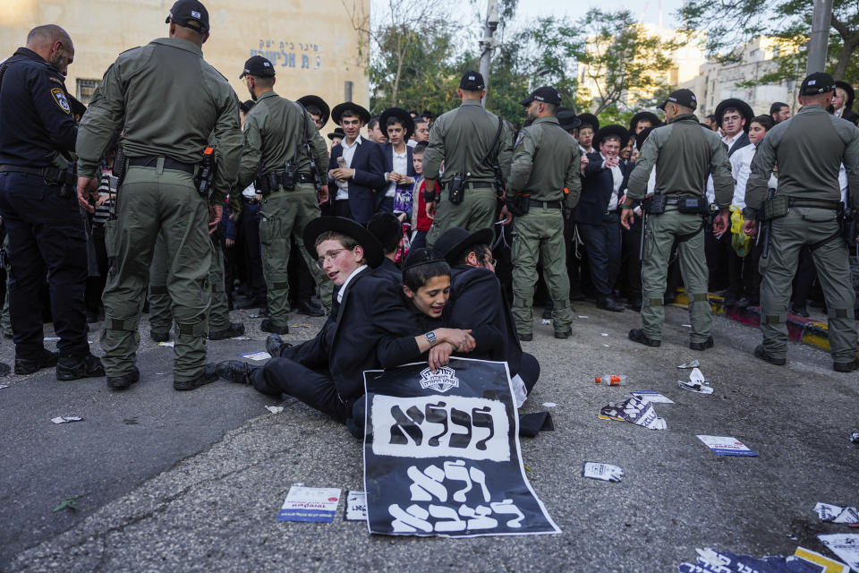 Ultra-Orthodox Jewish men hold a sign in Hebrew that reads "To jail and not to army" during a protest against army recruitment in Jerusalem on Thursday, April 11, 2024. Ultra-Orthodox men have long received exemptions from military service, which is compulsory for most Jewish men, generating widespread resentment. The Supreme Court has ordered the government to present a new proposal to force more religious men to enlist. (AP Photo/Ohad Zwigenberg)