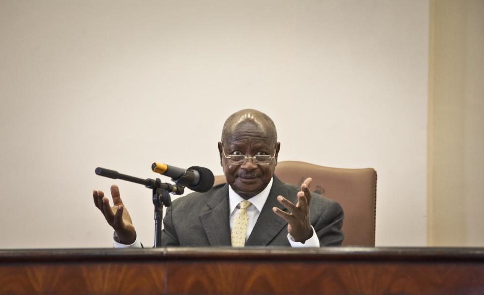 Uganda's President Yoweri Museveni gestures after signing a new anti-gay bill that sets harsh penalties for homosexual sex, in Entebbe, Uganda Monday, Feb. 24, 2014. Museveni on Monday signed the controversial anti-gay bill into law, with penalties including 14 years in jail for first-time offenders and life imprisonment as the maximum penalty for "aggravated homosexuality", saying it is needed to deter what he called the West's "social imperialism" promoting homosexuality in Africa. (AP Photo/Rebecca Vassie)