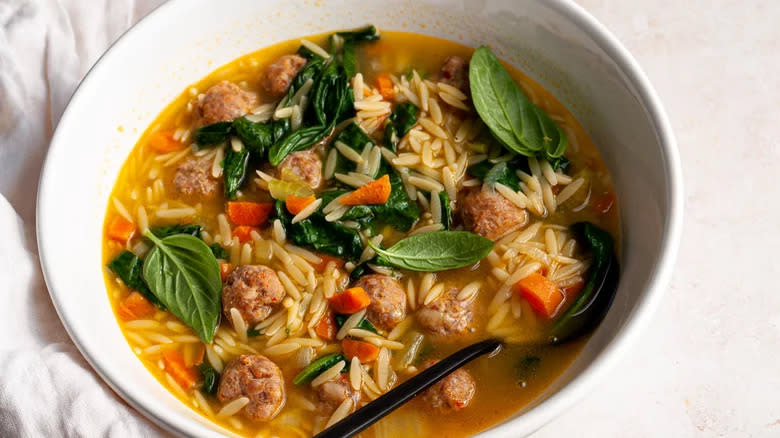 Meatball and orzo soup with basil and spinach