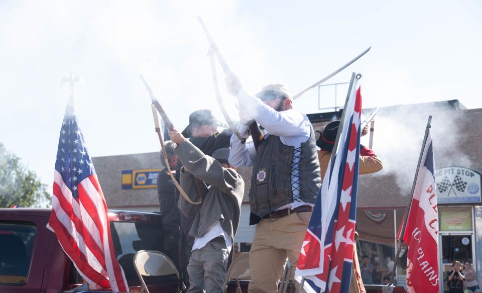 Two civil war reenactors fire their rifles into the air at the 104th annual Wheatheart of the Nation Parade Saturday in Perryton.