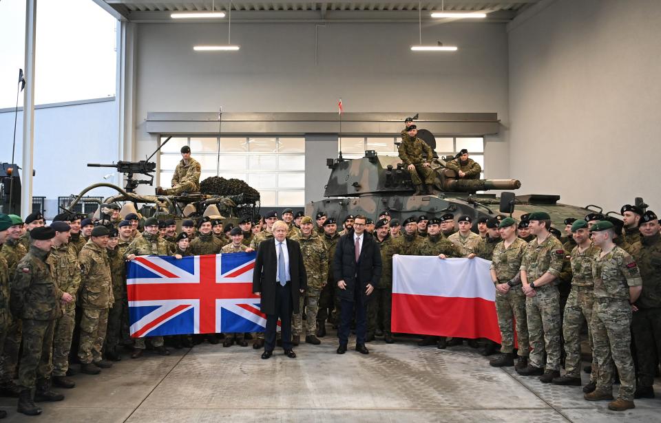 Boris Johnson and Polish prime minister Mateusz Morawiecki pose with British and Polish troops at Warszawska Brygada Pancerna military base in Warsaw (Getty)