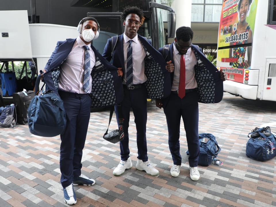 JSU players pose in their suits upon arrival in Miami.