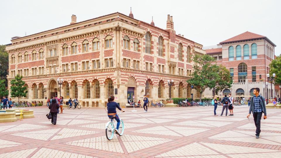 Students walk and bike at the University of Southern California campus in Los Angeles California USA.