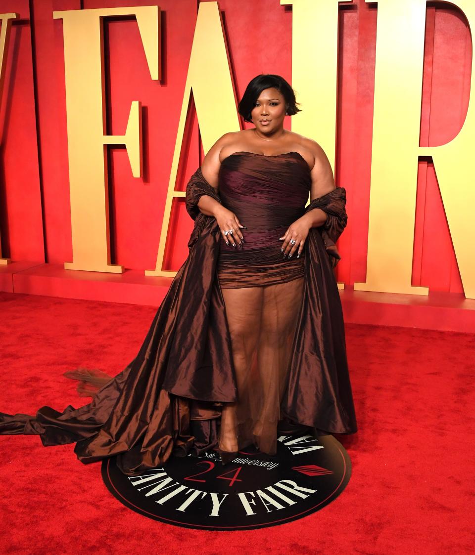 Image may contain: Lizzo, Fashion, Adult, Person, Accessories, Jewelry, Necklace, Clothing, Dress, Premiere, and Red Carpet