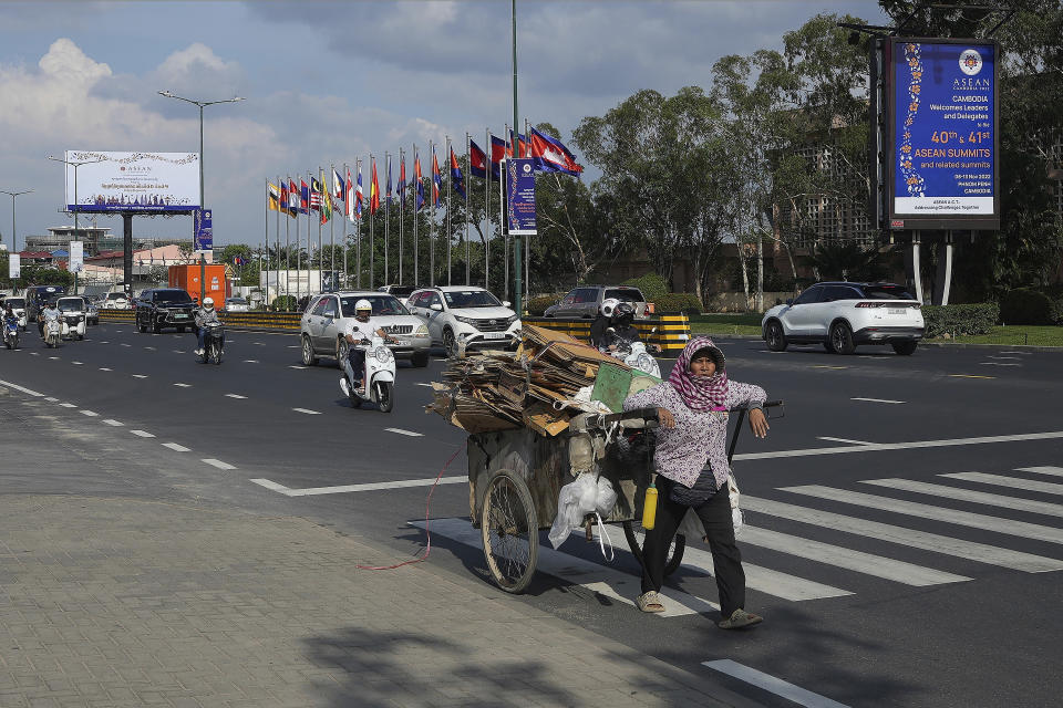 A recycler pulls her cart past a billboard advertising the upcoming Association of Southeast Asian Nations (ASEAN) summits in Phnom Penh, Cambodia, Tuesday, Nov. 8, 2022. Southeast Asian leaders convene in the Cambodian capital Thursday, faced with the challenge of trying to curtail escalating violence in Myanmar while the country’s military-led government shows no signs of complying with the group’s peace plan. (AP Photo/Heng Sinith)
