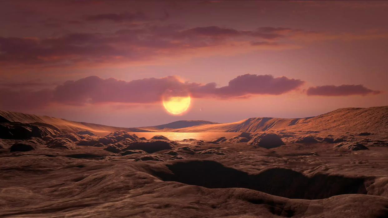 Image of rocky exoplanet with scudding clouds and a rough surface, orbiting a red dwarf star.