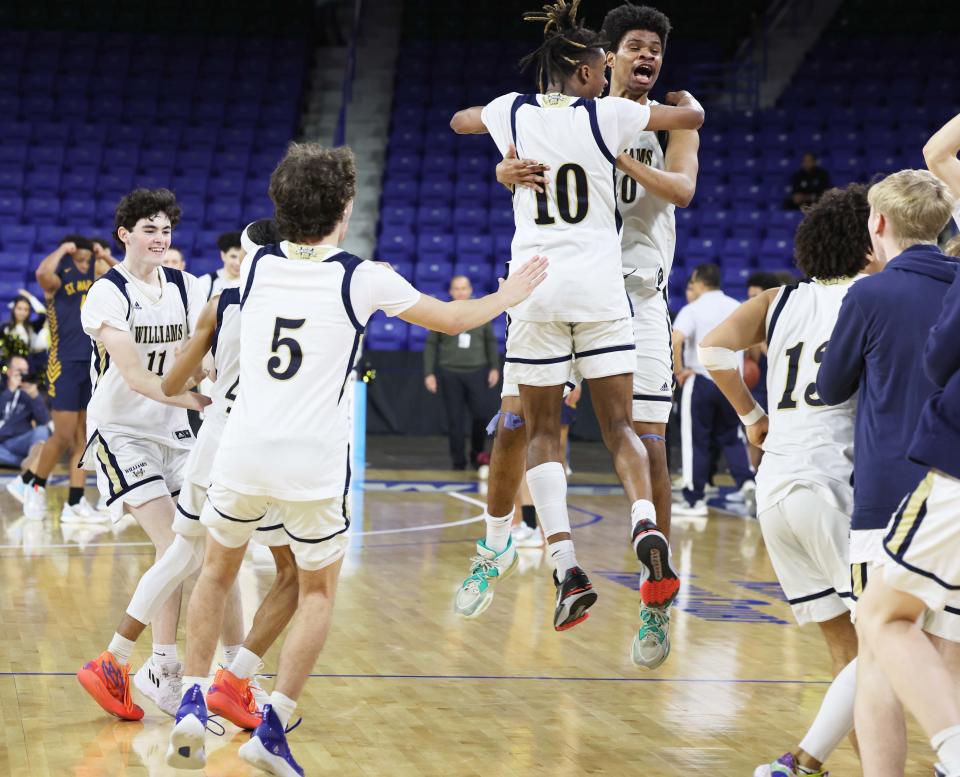 Archbishop Wlliams celebrate at the conclusion of   their MIAA Division 3 title game versus St. Mary's at the Tsongas Center in Lowell on Saturday, March 18, 2023.