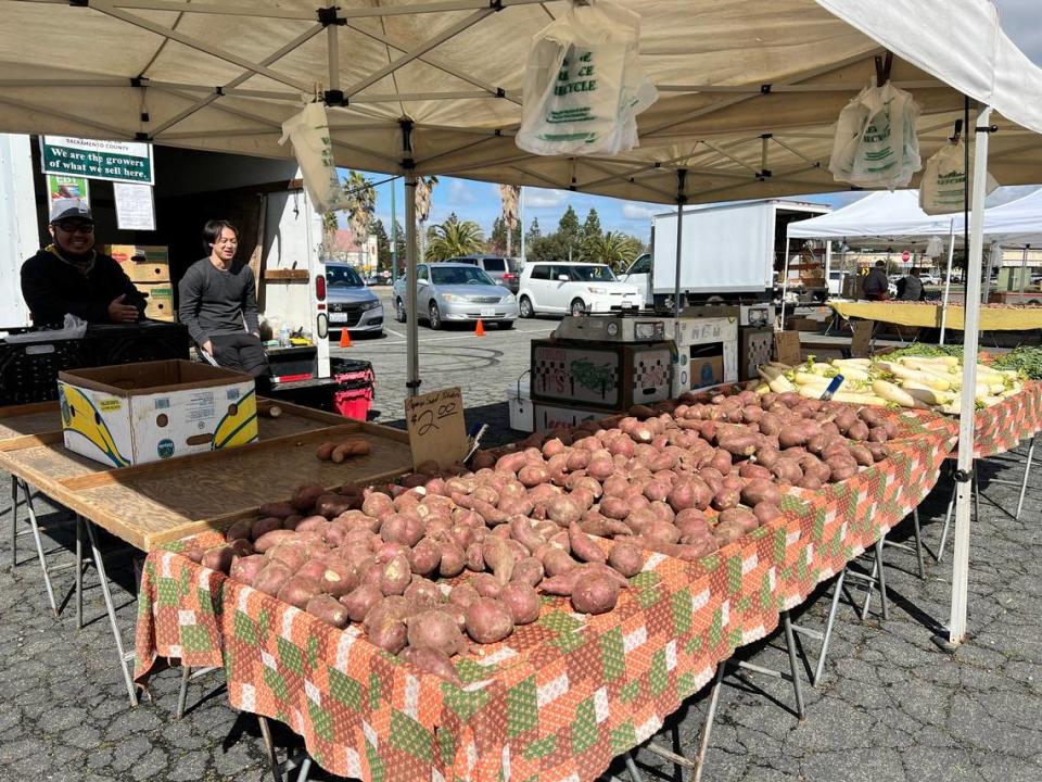 Tou Cor Khang and nephew Vincent Khang of T.C. Khang Farm in Sacramento at the Certified Farmers’ Market on Thursday, March 23, 2023.