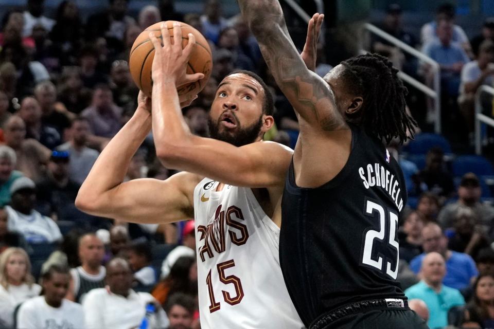 Cleveland Cavaliers' Isaiah Mobley (15) looks for an open shot against Orlando Magic's Admiral Schofield (25) during the first half of an NBA basketball game, Thursday, April 6, 2023, in Orlando, Fla. (AP Photo/John Raoux)