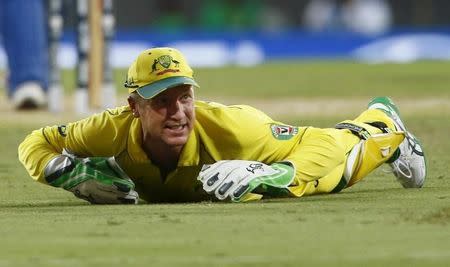 Australia's wicket keeper Brad Haddin reacts on the ground after missing a catch during his Cricket World Cup semi-final match against India in Sydney, March 26, 2015. REUTERS/David Gray