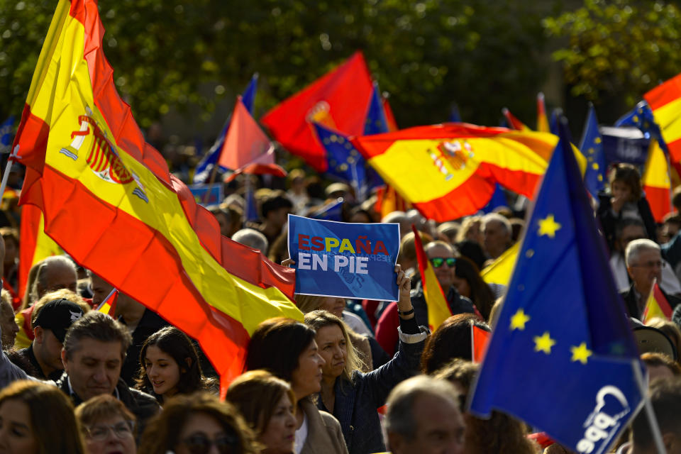 A crowd with Spanish flags pack Plaza del castillo square during a protest called by Spain's Conservative Popular Party in Pamplona, northern Spain, Sunday Nov.12, 2023. The Popular Party are protesting Spain's Socialists deal to grant amnesty to Catalan separatists in exchange for support of new government. (AP Photo/Alvaro Barrientos)