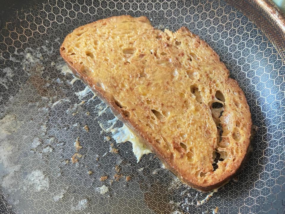 piece of french toast cooking in a pan