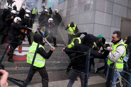 Demonstrators clash with police during the "yellow vests" protest against higher fuel prices, in Brussels, Belgium, December 8, 2018. REUTERS/Yves Herman