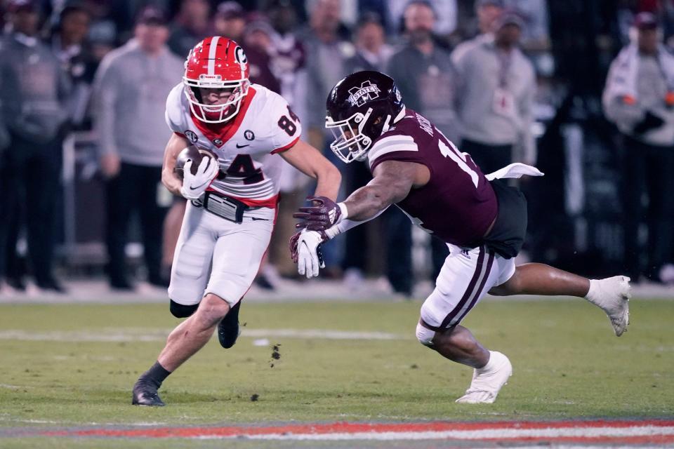 Georgia wide receiver Ladd McConkey (84) avoids a Mississippi State defender after catching a short pass during the first half of an NCAA college football game in Starkville, Miss., Saturday, Nov. 12 2022. (AP Photo/Rogelio V. Solis)
