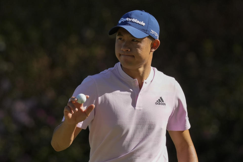 FILE - Collin Morikawa holds up his ball after an eagle putt on the 13th hole during the final round at the Masters golf tournament on Sunday, April 10, 2022, in Augusta, Ga. Morikawa is expected to compete in the U.S. Open in Brookline, Mass., to be played June 16-19. (AP Photo/Charlie Riedel, File)