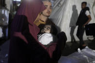 A Palestinian woman mourns her relative, 7-month old baby Hani Qeshta, who was killed in an Israeli bombardment on a residential building with Qeshta's family, at the morgue of Al Najjar hospital in Rafah, southern Gaza Strip, Sunday, May 5, 2024. (AP Photo/Ismael Abu Dayyah)
