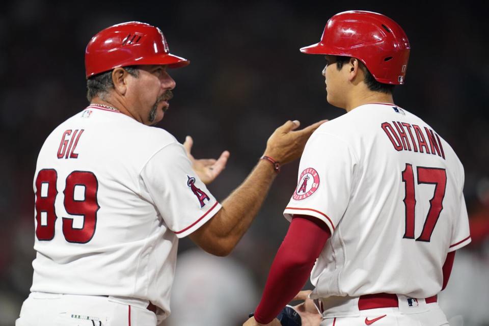 Benji Gil talks with Shohei Ohtani.