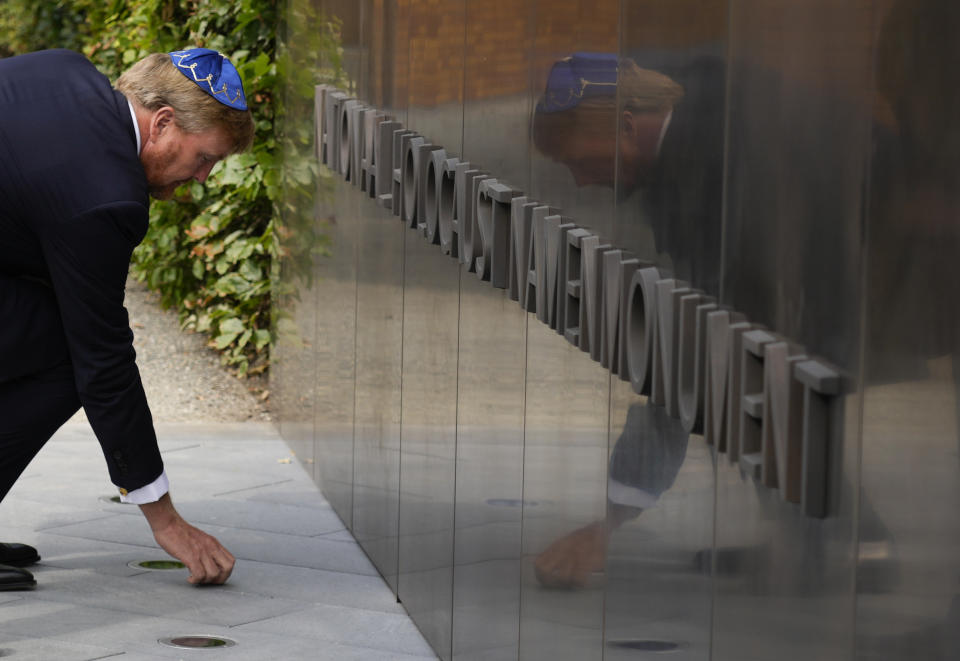 FILE - King Willem-Alexander puts a stone in an act of remembrance when unveiling a new monument in the heart of Amsterdam's historic Jewish Quarter on Sept. 19, 2021, honoring the 102,000 Dutch victims of the Holocaust. A Jewish group that commissioned a survey on Holocaust awareness in the Netherlands said Wednesday, Jan. 25, 2023 that the results show "a disturbing lack of awareness of key historical facts about the Holocaust," prompting calls for better education in the nation that was home to diarist Anne Frank and her family. (AP Photo/Peter Dejong, File)