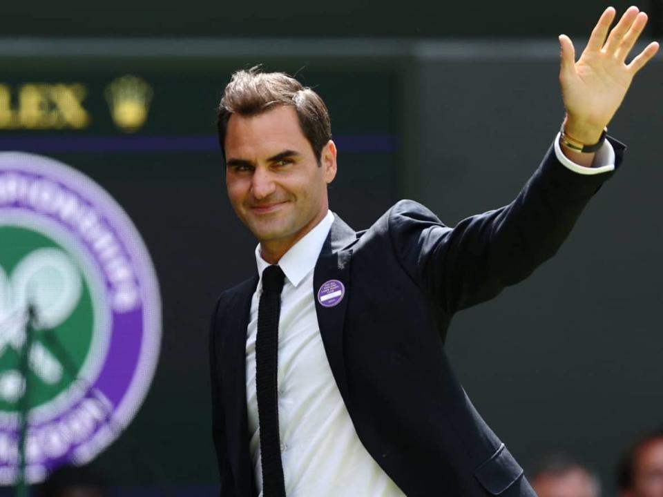 Roger Federer waves during the Centre Court Centenary Ceremony during the Wimbledon championships in July.  (Adrian Dennis/AFP via Getty Images - image credit)